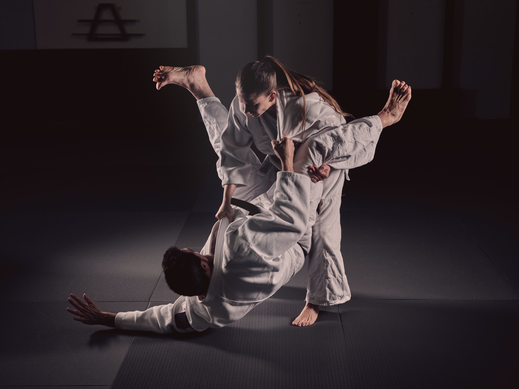 Woman practicing martial arts with man
